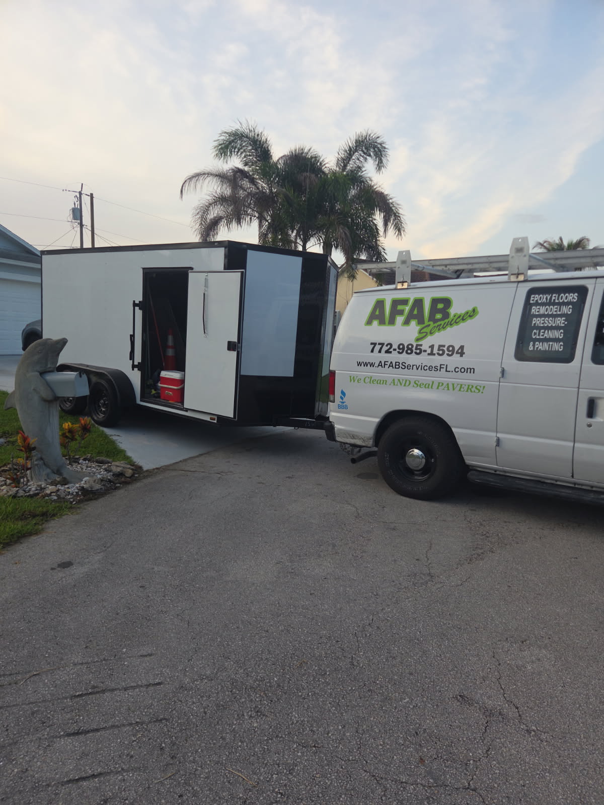 AFAB Services van and enclosed trailer parked at a customer's home