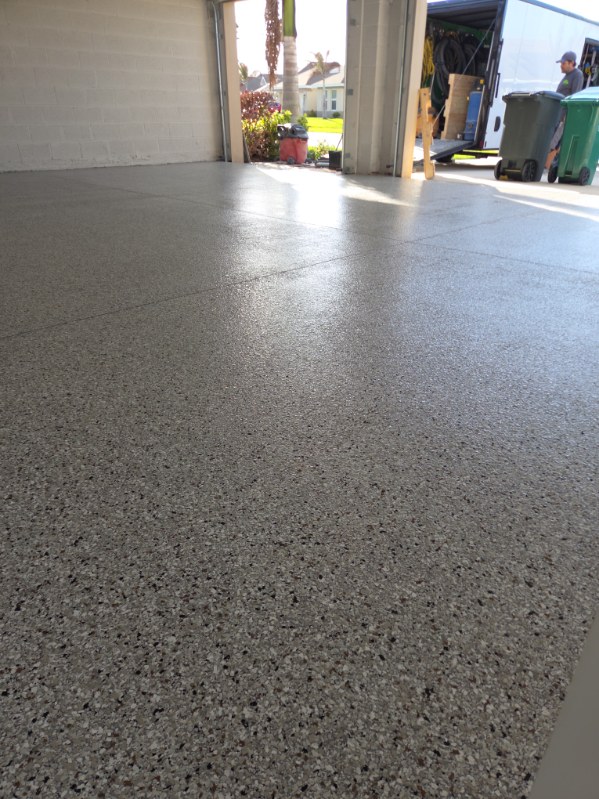 Tan and brown flake epoxy floor in an open garage