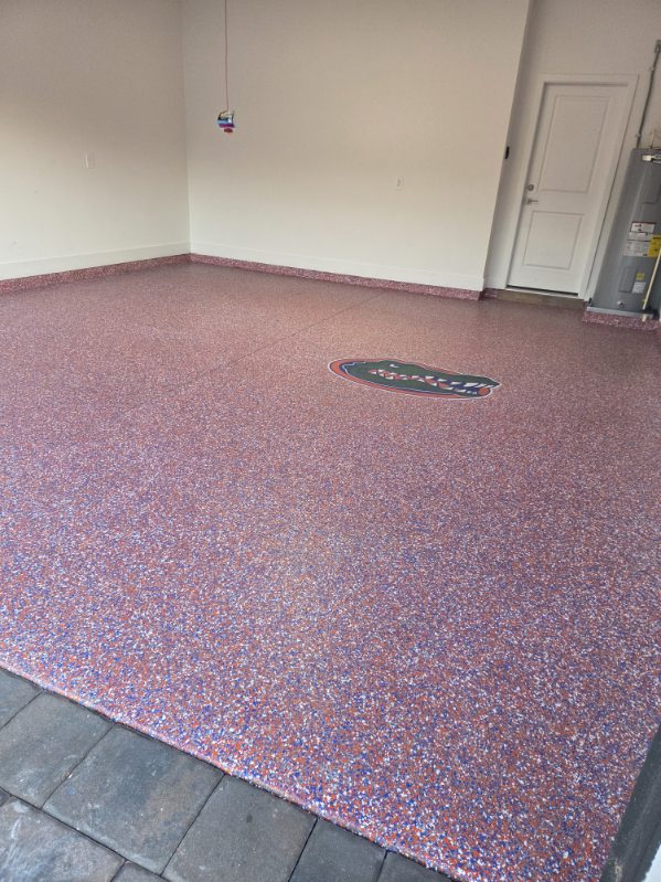 Red, white and blue flake epoxy garage floor with a team logo inlay